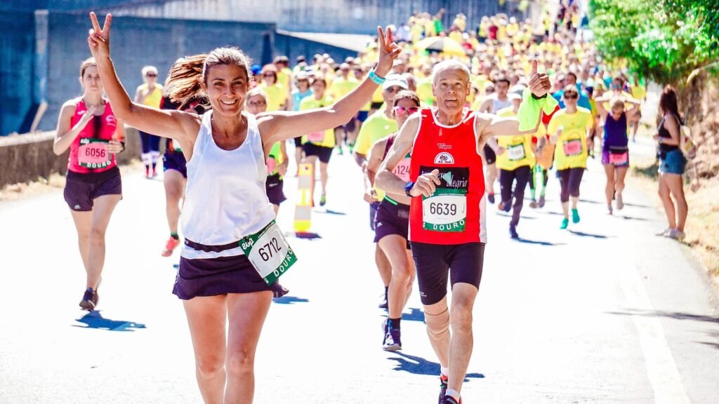 A woman finishing a race. She got back into running and met her goals.