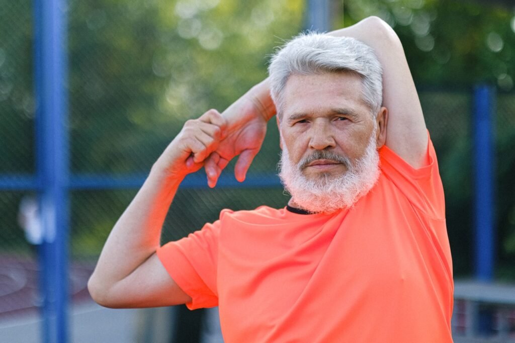 An old man stretching before running for general fitness.