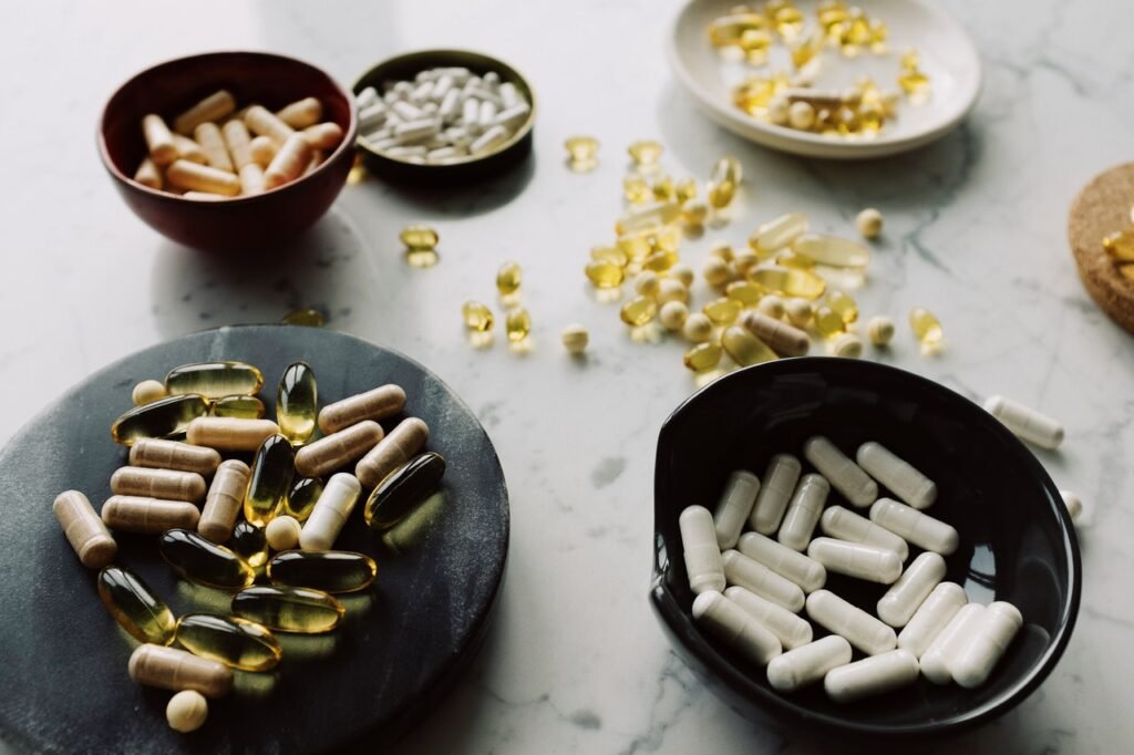 A variety of pills on a table. Supplements are a common tool used for recovery, and there is little evidence they work.