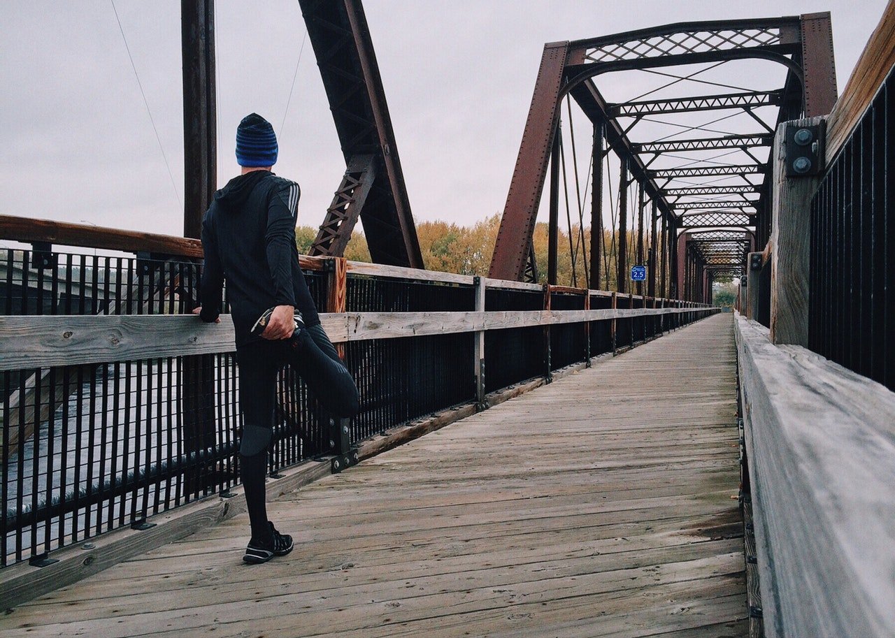 A runner on a bridge, training for a 5k.