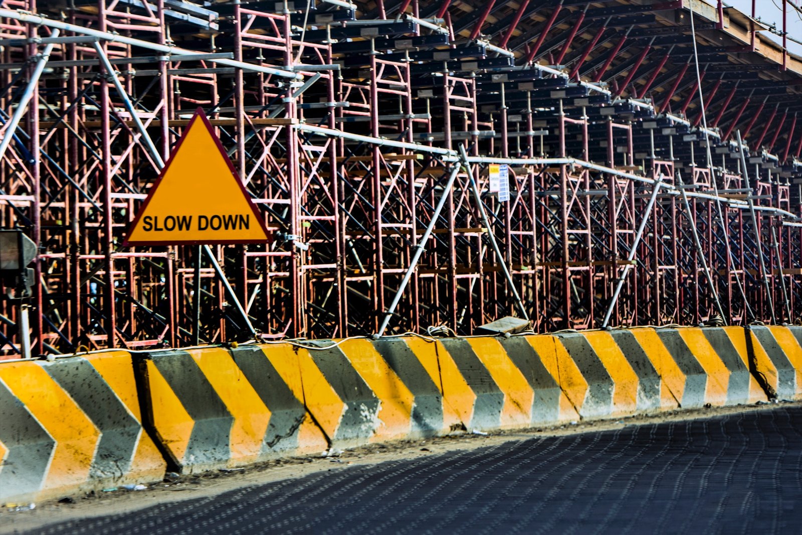 A construction site with a "Slow Down" sign. Slowing down is an important part of tapering and recovering.