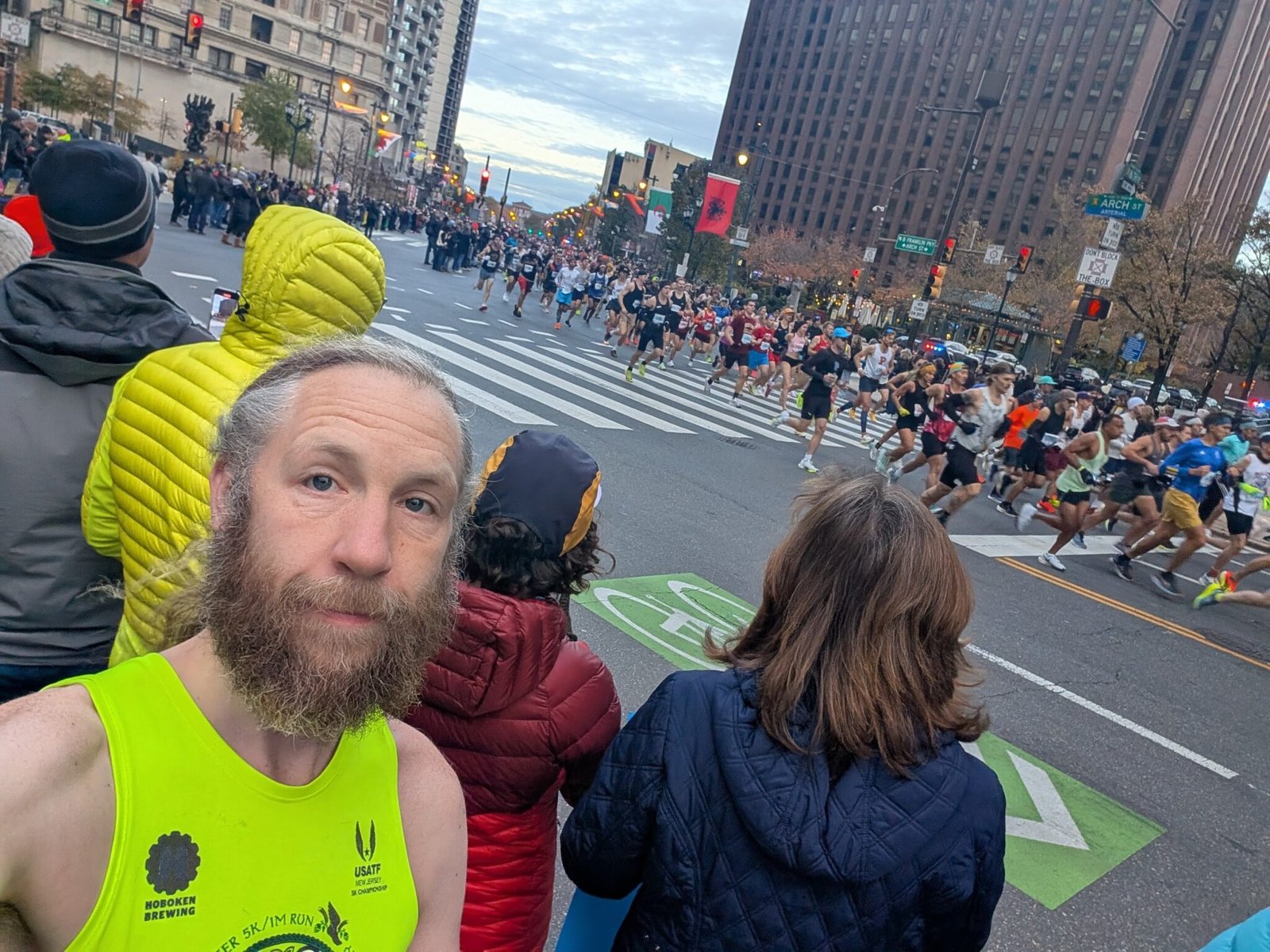 A selfie of me watching the 2024 Philly Marathon, with the starting wave in the background