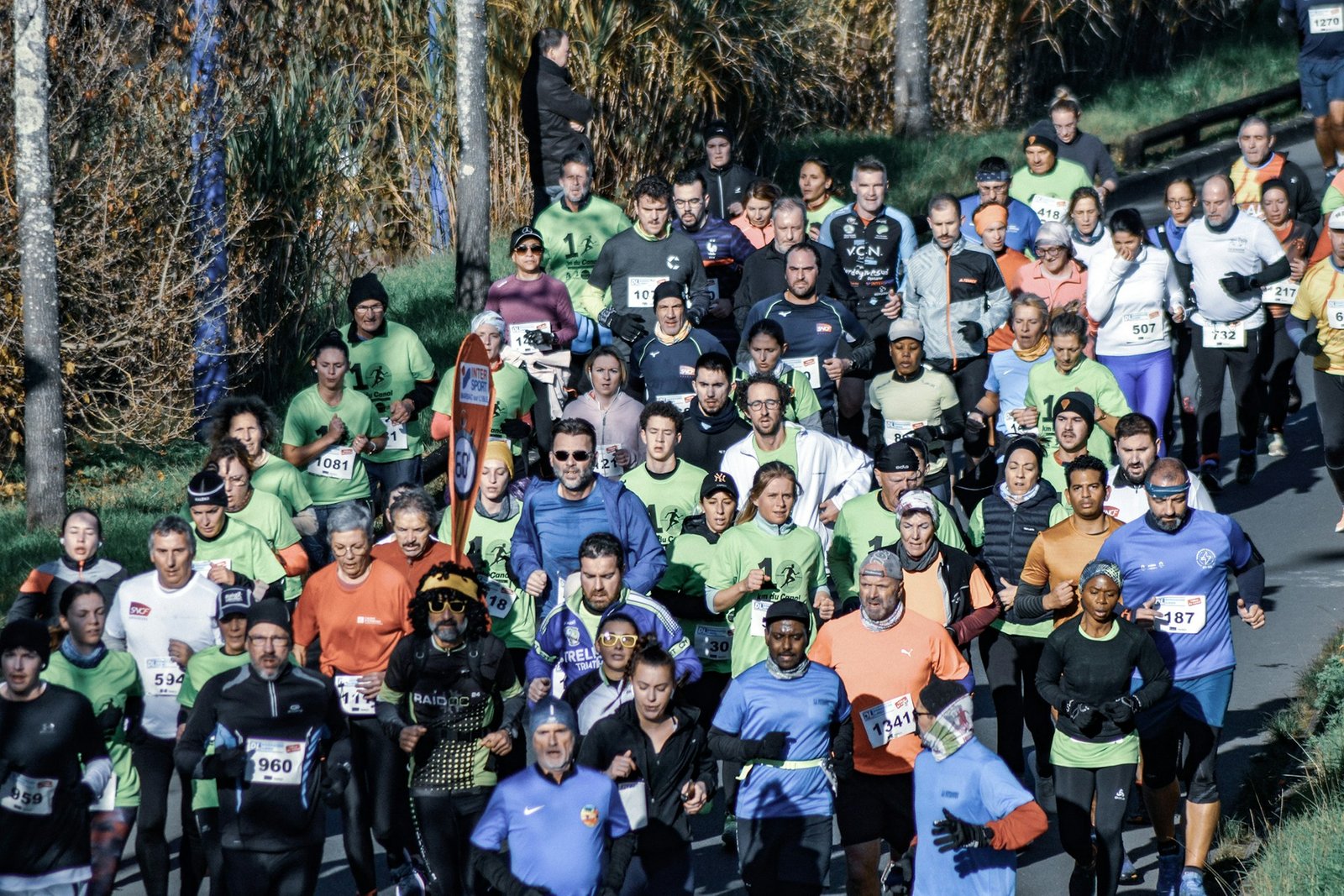 A group of runners dressed in winter running gear for a race in cold weather.