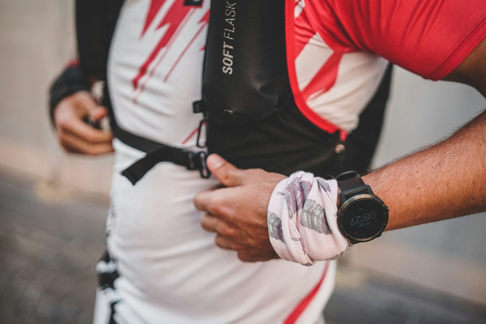 A trail runner with a black Garmin watch on his left wrist.